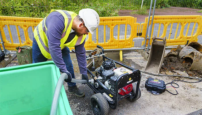 Engineer using specialist pressure testing equipment on a worksite